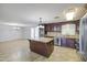 Well-lit kitchen boasting a center island, stainless steel appliances, granite counters, and tile floors at 1911 N 42Nd Ave, Phoenix, AZ 85009