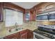 Close up of kitchen featuring stainless steel appliances, granite countertops, and beautiful cabinetry at 1911 N 42Nd Ave, Phoenix, AZ 85009