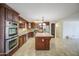 Bright kitchen showcasing stainless steel appliances, granite countertops, a central island and tile flooring at 1911 N 42Nd Ave, Phoenix, AZ 85009