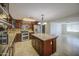 Open kitchen boasts a center island, stainless appliances, granite counters, and tile flooring at 1911 N 42Nd Ave, Phoenix, AZ 85009