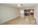 Open layout: living room flows into the kitchen, featuring tile floors and neutral tones at 1911 N 42Nd Ave, Phoenix, AZ 85009