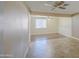 Cozy living room featuring tile flooring, a ceiling fan, and a view into an adjacent area at 1911 N 42Nd Ave, Phoenix, AZ 85009