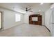 Spacious living room with tile floors, ceiling fan, and a built-in entertainment center at 1911 N 42Nd Ave, Phoenix, AZ 85009