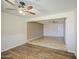 Bright living area with wood flooring, a ceiling fan, and an elevated tile platform at 1911 N 42Nd Ave, Phoenix, AZ 85009