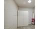 Versatile room with a large closet, pegboard wall, and light tile flooring at 1911 N 42Nd Ave, Phoenix, AZ 85009