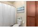 Clean bathroom with a shower featuring a curtain, and cabinet with storage at 1941 S Pierpont Dr # 1037, Mesa, AZ 85206