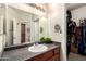Bathroom featuring a large mirror over the sink, storage, and a closet at 1941 S Pierpont Dr # 1037, Mesa, AZ 85206