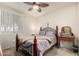 Cozy bedroom features a ceiling fan, large window, and vintage furnishings at 1941 S Pierpont Dr # 1037, Mesa, AZ 85206