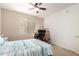 Bright bedroom featuring a ceiling fan, a workspace and large windows at 1941 S Pierpont Dr # 1037, Mesa, AZ 85206