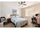 Neutral bedroom featuring a ceiling fan, a workspace and large windows at 1941 S Pierpont Dr # 1037, Mesa, AZ 85206