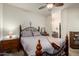 This bedroom has an attached bathroom, vintage furniture, and neutral carpet at 1941 S Pierpont Dr # 1037, Mesa, AZ 85206
