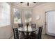 Cozy dining area featuring a round table and natural light from the large windows at 1941 S Pierpont Dr # 1037, Mesa, AZ 85206