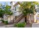 Charming condo featuring tan exterior, stairway to the front door, and mature landscaping at 1941 S Pierpont Dr # 1037, Mesa, AZ 85206