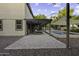 The backyard features a covered patio with outdoor furniture, a swimming pool, and desert landscaping at 1953 E Lafayette Ave, Gilbert, AZ 85298