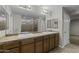 Bathroom with double sinks, granite countertop, framed mirrors, and modern lighting at 1953 E Lafayette Ave, Gilbert, AZ 85298
