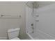 Bathroom with white tiled shower-tub combination and standard toilet at 1953 E Lafayette Ave, Gilbert, AZ 85298