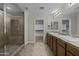 Bathroom featuring a glass shower and double sink vanity with wood cabinets at 1953 E Lafayette Ave, Gilbert, AZ 85298