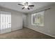Bedroom featuring neutral walls, carpet, ceiling fan, and bright window at 1953 E Lafayette Ave, Gilbert, AZ 85298