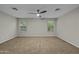 Bright bedroom featuring carpeted floors, neutral walls, and two windows at 1953 E Lafayette Ave, Gilbert, AZ 85298