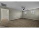 Spacious bedroom with neutral walls, ceiling fan, plush carpeting, and natural light from the windows at 1953 E Lafayette Ave, Gilbert, AZ 85298