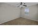 Bedroom featuring neutral walls, carpet, ceiling fan, and bright window at 1953 E Lafayette Ave, Gilbert, AZ 85298