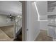 Hallway with a staircase, door, and view into a living room, seamlessly connecting the home's living spaces at 1953 E Lafayette Ave, Gilbert, AZ 85298