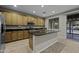 Modern kitchen featuring granite countertops, stainless steel appliances, an island, and a sliding glass door to the backyard at 1953 E Lafayette Ave, Gilbert, AZ 85298