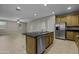 A kitchen island with stainless steel appliances and tile floors at 1953 E Lafayette Ave, Gilbert, AZ 85298