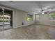 A bright living room with a ceiling fan, tile floors, and access to the patio at 1953 E Lafayette Ave, Gilbert, AZ 85298