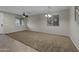 Spacious living room with a ceiling fan, neutral walls, and plush carpeting creating a comfortable and inviting ambiance at 1953 E Lafayette Ave, Gilbert, AZ 85298
