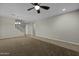 Open-concept living room with modern ceiling fan and staircase access, providing an inviting and airy atmosphere at 1953 E Lafayette Ave, Gilbert, AZ 85298