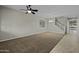 Empty living room featuring fresh carpet and a ceiling fan; great potential for customization at 1953 E Lafayette Ave, Gilbert, AZ 85298