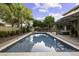 Beautiful backyard with a sparkling pool, covered patio, and lush greenery for ultimate relaxation at 1953 E Lafayette Ave, Gilbert, AZ 85298