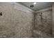 Detail of shower with seat, rain shower head, and handheld shower fixture at 1953 E Lafayette Ave, Gilbert, AZ 85298