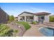 Expansive backyard showcasing lush landscaping, a covered patio, and sparkling pool for outdoor enjoyment at 20438 W Calle Encorvada --, Buckeye, AZ 85396