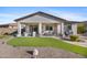 Backyard with covered patio, stylish outdoor seating, and an expansive artificial lawn at 20438 W Calle Encorvada --, Buckeye, AZ 85396