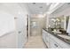 Main bathroom features a double sink vanity, stone floors, and a large stand up shower at 20438 W Calle Encorvada --, Buckeye, AZ 85396