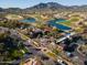 Aerial view of community with lush golf courses, scenic lakes, palm trees, and well-maintained landscaping at 20438 W Calle Encorvada --, Buckeye, AZ 85396