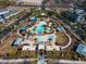 Aerial view of resort-style community pool with palm trees, cabanas, and ample seating for relaxation and entertainment at 20438 W Calle Encorvada --, Buckeye, AZ 85396