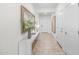 Bright entryway featuring tile flooring, white walls, a console table with decor, and white doors at 20438 W Calle Encorvada --, Buckeye, AZ 85396