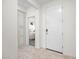 Bright entryway with a large white door, storage cupboard, and view into bedroom with neutral tones at 20438 W Calle Encorvada --, Buckeye, AZ 85396