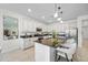 Bright kitchen features an island with barstool seating, stainless steel appliances, and white cabinetry at 20438 W Calle Encorvada --, Buckeye, AZ 85396