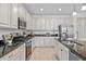 Bright kitchen with black countertops, stainless steel appliances, and white cabinets at 20438 W Calle Encorvada --, Buckeye, AZ 85396