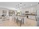 Bright kitchen features an island with barstool seating, stainless steel appliances, and modern pendant lighting at 20438 W Calle Encorvada --, Buckeye, AZ 85396