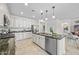 Spacious kitchen features an island with sink, stainless steel appliances, and white cabinetry at 20438 W Calle Encorvada --, Buckeye, AZ 85396