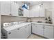 Functional laundry room featuring modern appliances, ample storage cabinets, and a neutral color palette at 20438 W Calle Encorvada --, Buckeye, AZ 85396