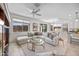 Bright living room with a sectional sofa, views of the backyard, and an open layout at 20438 W Calle Encorvada --, Buckeye, AZ 85396