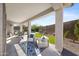 Covered patio with comfortable seating and views of the outdoor living space with mature landscaping at 20438 W Calle Encorvada --, Buckeye, AZ 85396