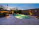 Backyard pool featuring ambient lighting, decorative landscaping, and a private setting for relaxation at 20438 W Calle Encorvada --, Buckeye, AZ 85396