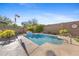 Enjoy a swimming pool with lovely water feature, desert landscaping, and a secure block fence at 20438 W Calle Encorvada --, Buckeye, AZ 85396